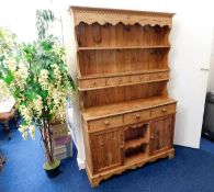 A farmhouse style pine dresser with two cupboards