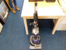 A Dyson vacuum cleaner with attachment