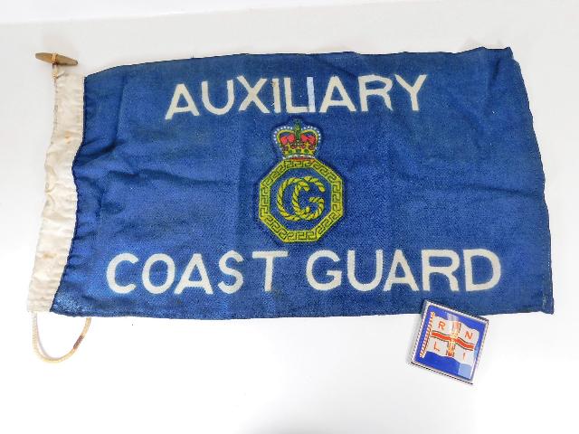 A Coast Guard flag twinned with RNLI plaque