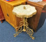 An onyx topped lamp table with brass fittings