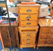 A pair of three drawer bedside table