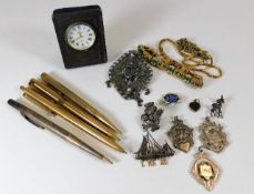 A silver thistle brooch, three silver medals, a si