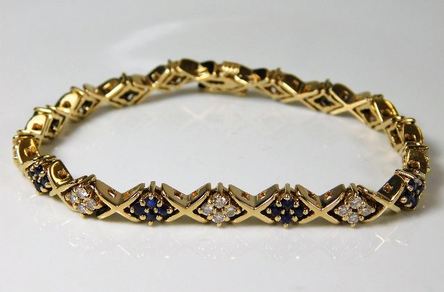 A 14ct gold diamond & sapphire bracelet 20.5g 7.5i