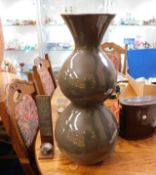 A large retro style vase twinned with a candle hol