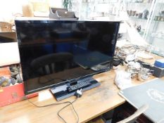 A Toshiba flat screen television with remote