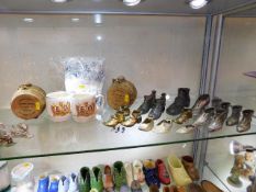 A selection of metal collectable shoes twinned wit