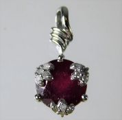 A 9ct white gold pendant set with ruby & diamond 1