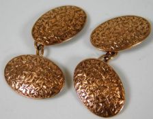 A pair of 9ct gold cufflinks with foliage decor &