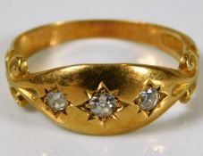 An 18ct gold three stone diamond ring size L 2.9g