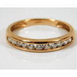 A 14ct gold half eternity ring set with white ston