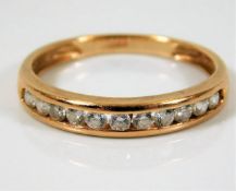 A 14ct gold half eternity ring set with white ston