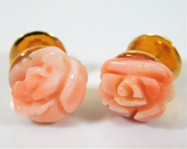 An 18ct gold pair of carved pink coral earrings de