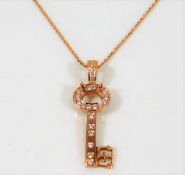 An 18ct rose gold key pendant & chain set with 0.5