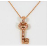 An 18ct rose gold key pendant & chain set with 0.5