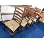 A set of four antique ladder back rush seat chairs