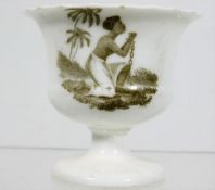 A 19thC. egg cup with slave trade motive