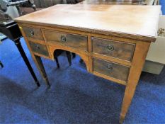 A mahogany lowboy with five drawers