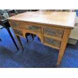 A mahogany lowboy with five drawers