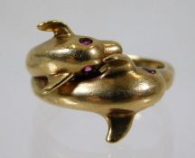 A 9ct gold "dolphin" ring set with red stones 5.4g