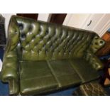 A green leather Chesterfield sofa