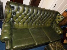 A green leather Chesterfield sofa