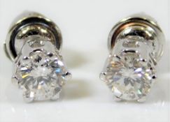 A pair of 18ct white gold earrings set with approx