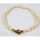 A pearl bracelet set with yellow metal clasp, test
