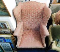 A George III upholstered wing back chair. Provenan