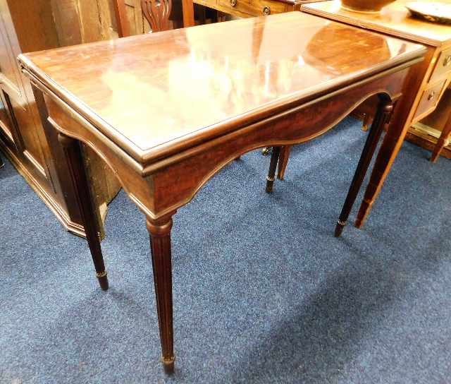 A mahogany card table with reeded legs. Provenance