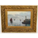 A gilt framed oil on panel depicting Newlyn harbou