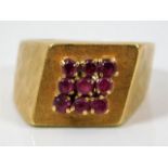 An 18ct gold ring set with nine rubies size L/M 7g