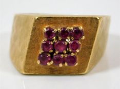 An 18ct gold ring set with nine rubies size L/M 7g