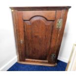 A small 19thC. oak wall mounted corner cabinet