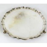 A footed silver salver with crimped edge by Hawksw