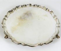 A footed silver salver with crimped edge by Hawksw