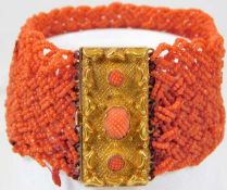 A 19thC. woven coral bracelet set with yellow meta