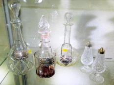 Three decanters with silver labels twinned with a