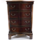 A mahogany serpentine chest of four drawers