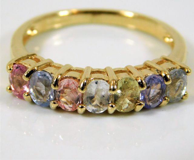 A 9ct gold ring set with rainbow colour sapphires