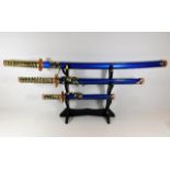 A mounted set of three Samurai swords