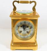 A large J. Wilkinson brass carriage clock with com