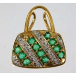 A 9ct gold handbag pendant set with diamonds & eme