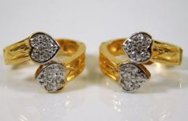 A pair of 14ct gold earrings set with 0.25ct diamo