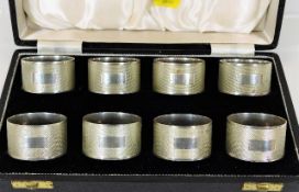 A cased set of eight silver napkin rings 246.6g