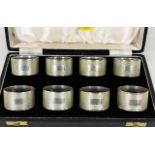 A cased set of eight silver napkin rings 246.6g