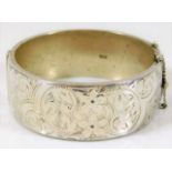 A silver bangle with chased decor, 2.5in diameter