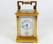 A brass J. Sewill carriage clock with enamelled dial 7.75in high, not running