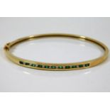 A 10ct gold bangle set with diamond & emerald 8.3g