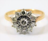 An 18ct gold daisy style ring set with approx.0.6ct diamonds 3.4g size L/M