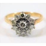 An 18ct gold daisy style ring set with approx.0.6ct diamonds 3.4g size L/M